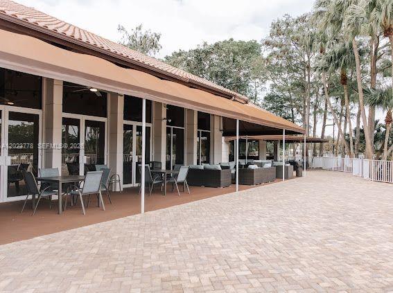 10245 Vía Hibiscus, Unit 10245 Boca Raton, FL 33428 - Photo 21 of 28 a view of a house with chairs in patio