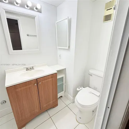 a bathroom with a sink a toilet and mirror