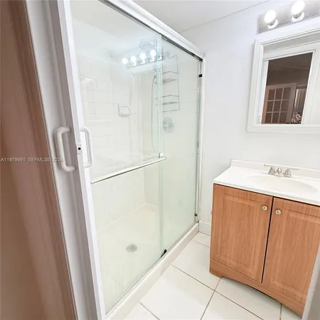 a bathroom with a shower and a sink