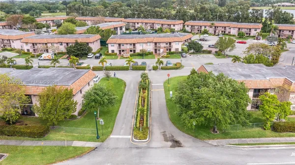 an aerial view of a house with garden space and street view