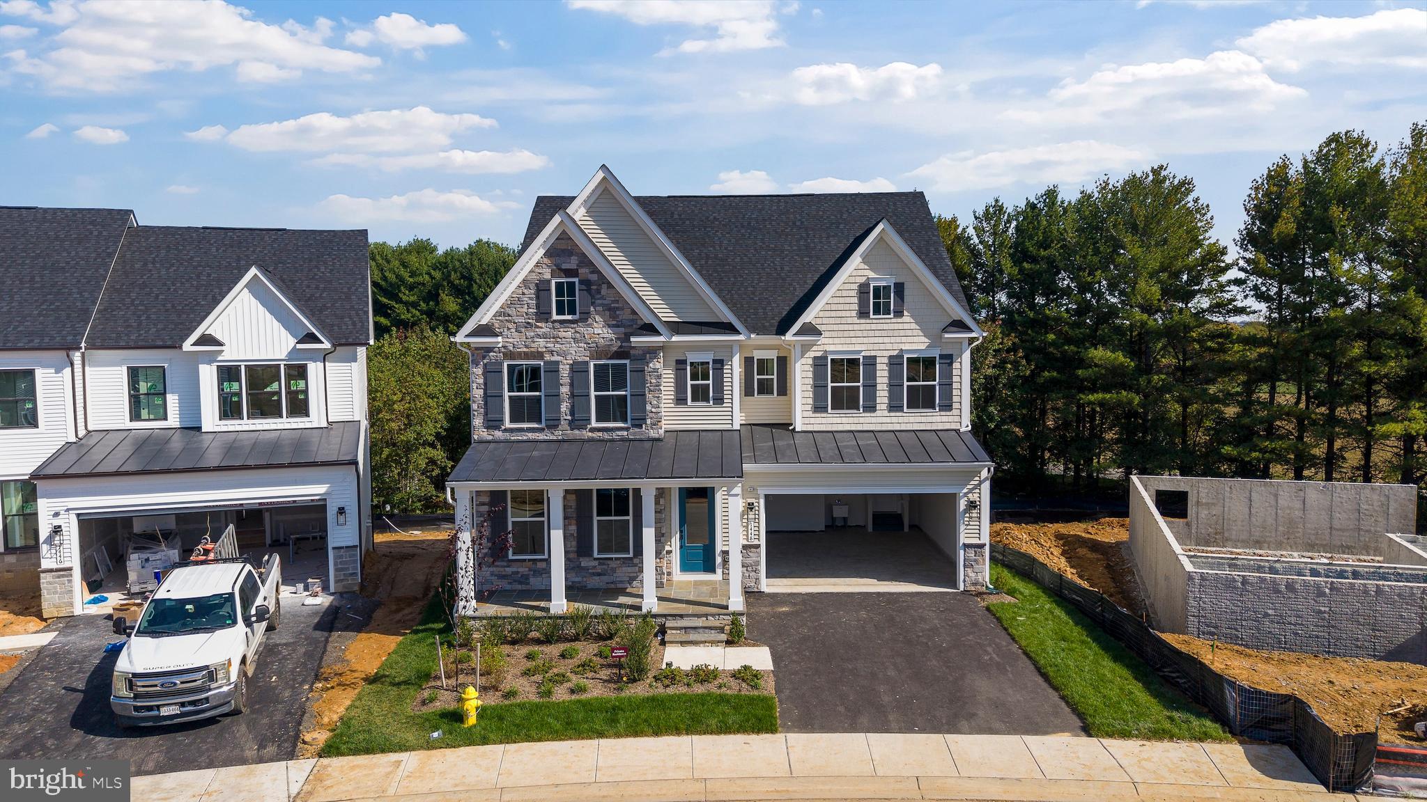 a aerial view of a house with yard porch and furniture