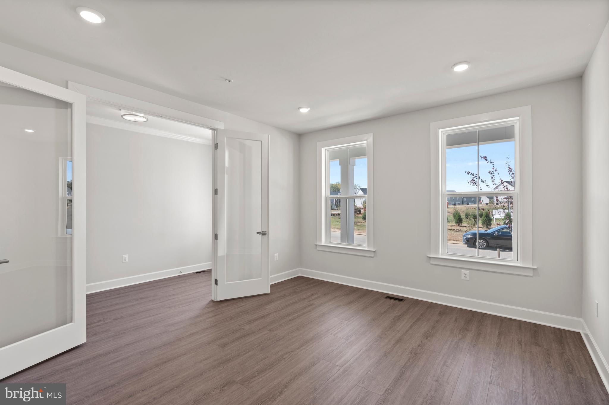 1448 Lavender Cliff Way Odenton, MD 21113 - Photo 16 of 94 a view of an empty room with wooden floor and a window