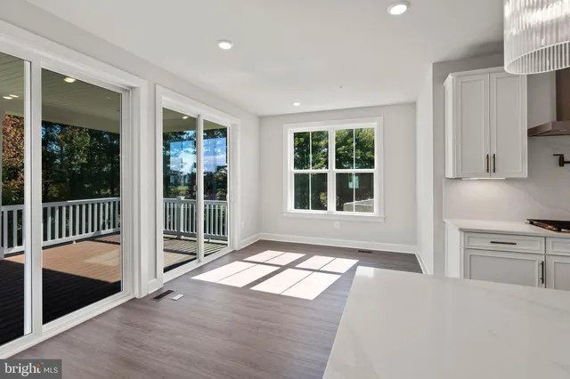 a view of a kitchen with wooden floor and a window