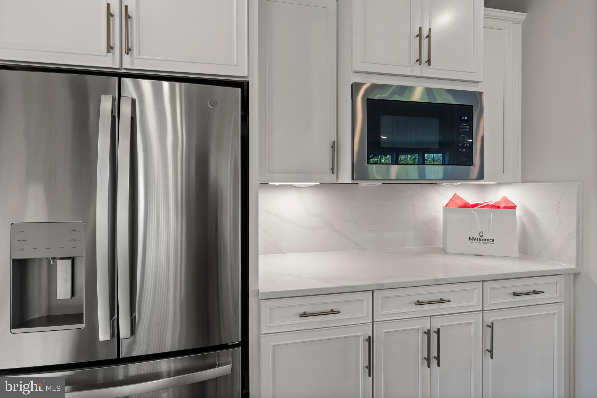 1448 Lavender Cliff Way Odenton, MD 21113 - Photo 31 of 94 a kitchen with white cabinets and stainless steel appliances