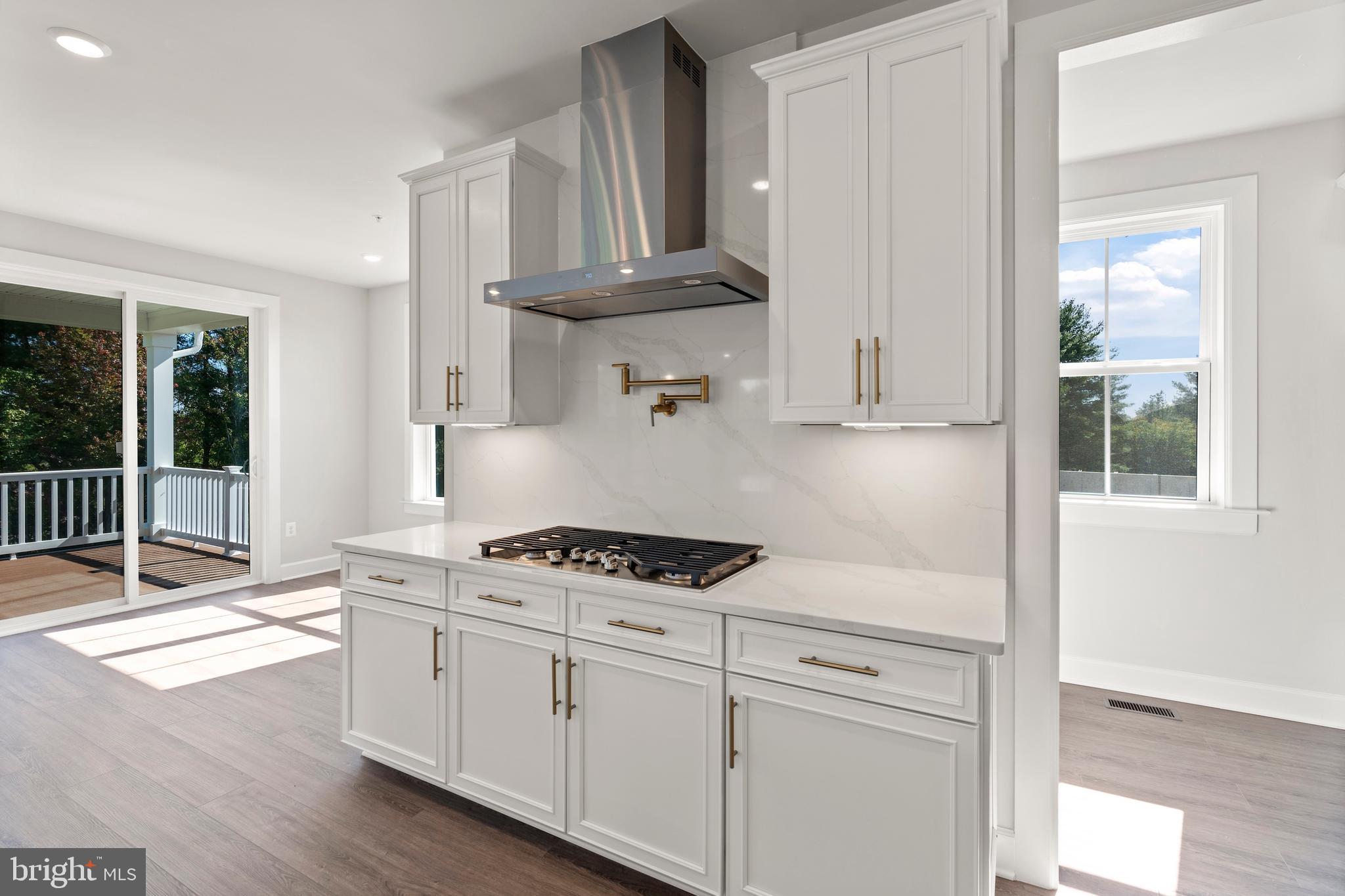 1448 Lavender Cliff Way Odenton, MD 21113 - Photo 33 of 94 a kitchen with granite countertop a stove a sink and a microwave
