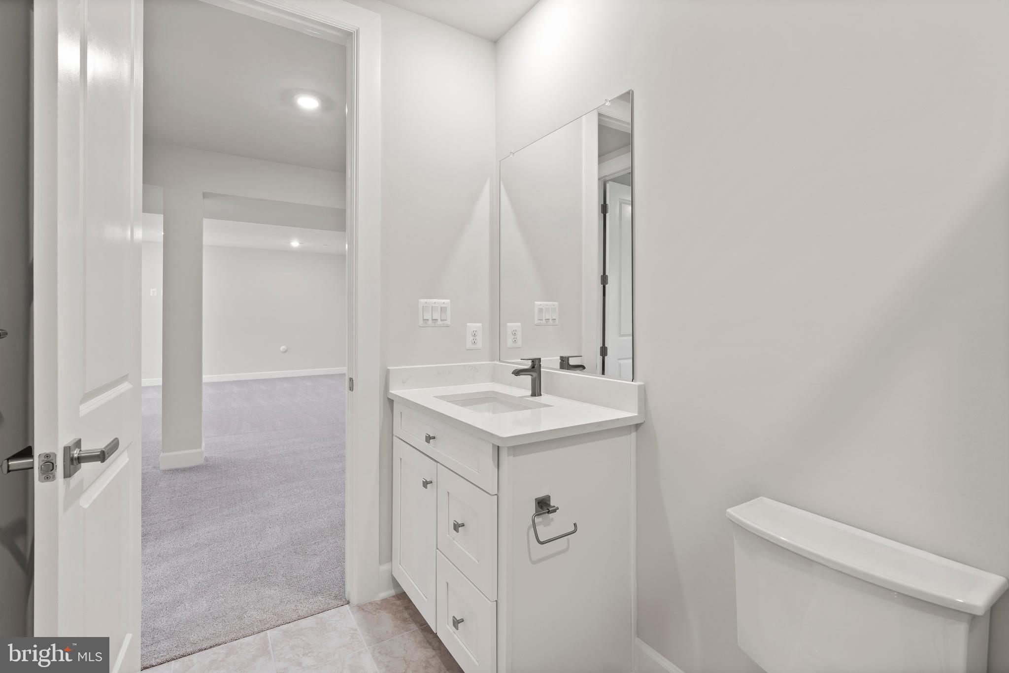 1448 Lavender Cliff Way Odenton, MD 21113 - Photo 40 of 94 a bathroom with a sink a toilet a mirror and vanity
