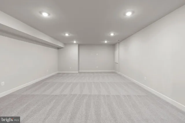 a bath tub sitting in a bathroom next to a window