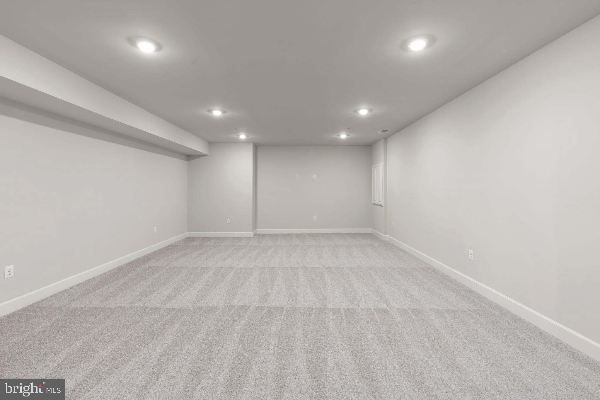 1448 Lavender Cliff Way Odenton, MD 21113 - Photo 49 of 94 an empty room with a white wall and wooden floor