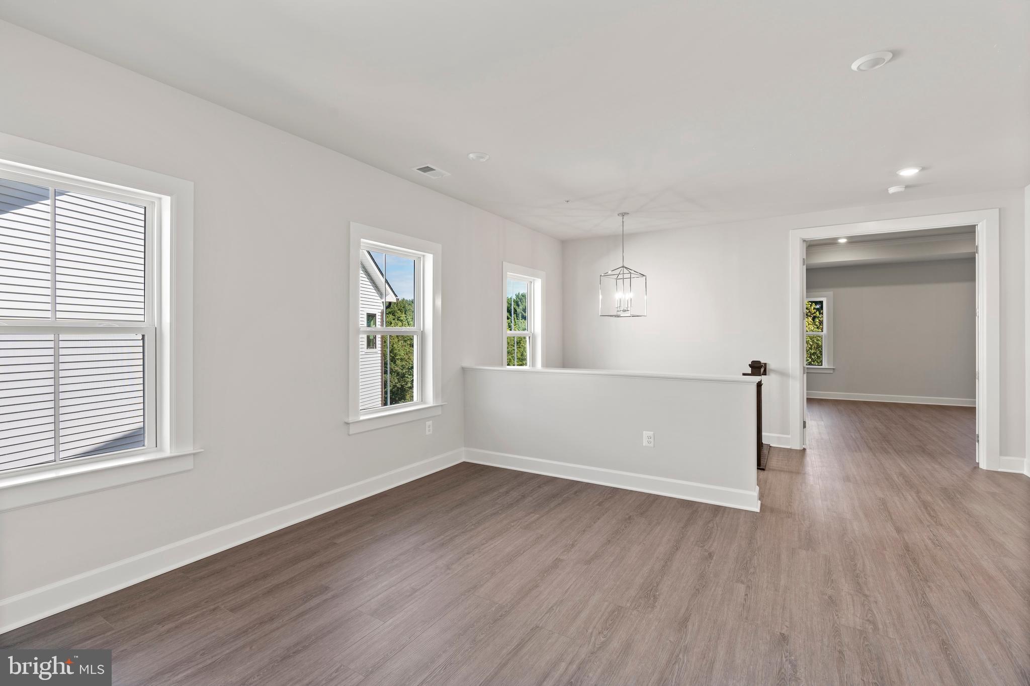 1448 Lavender Cliff Way Odenton, MD 21113 - Photo 55 of 94 an empty room with wooden floor and windows
