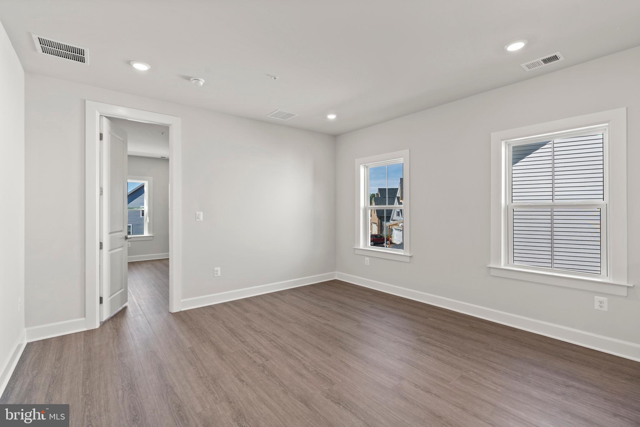 1448 Lavender Cliff Way Odenton, MD 21113 - Photo 57 of 94 an empty room with wooden floor and windows