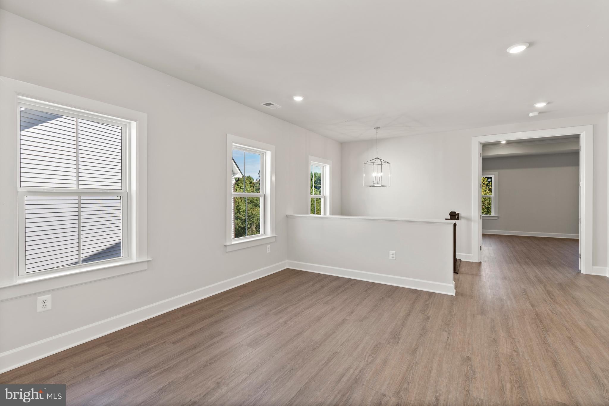 1448 Lavender Cliff Way Odenton, MD 21113 - Photo 58 of 94 an empty room with wooden floor and windows