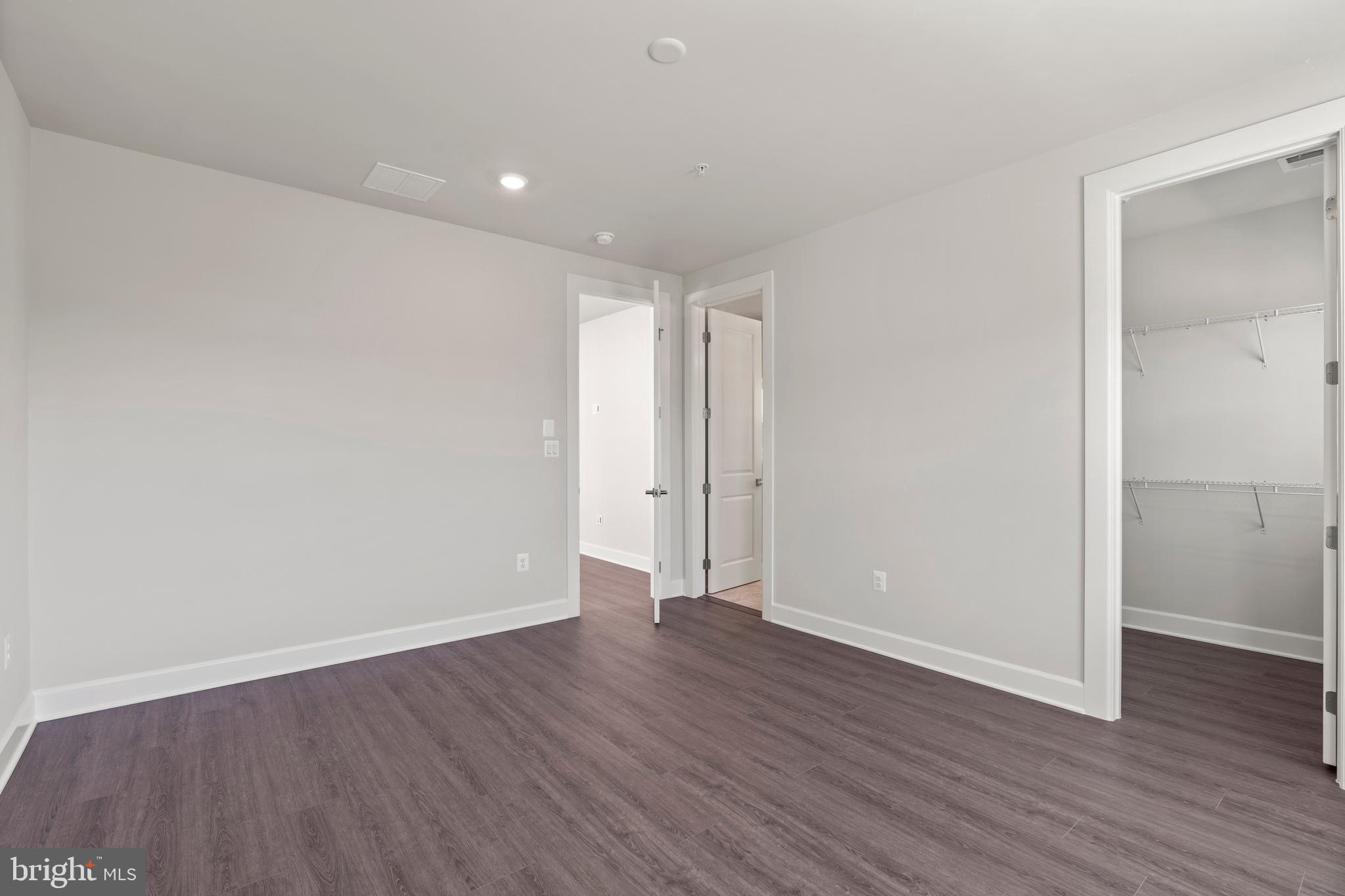 1448 Lavender Cliff Way Odenton, MD 21113 - Photo 60 of 94 a view of an empty room with wooden floor