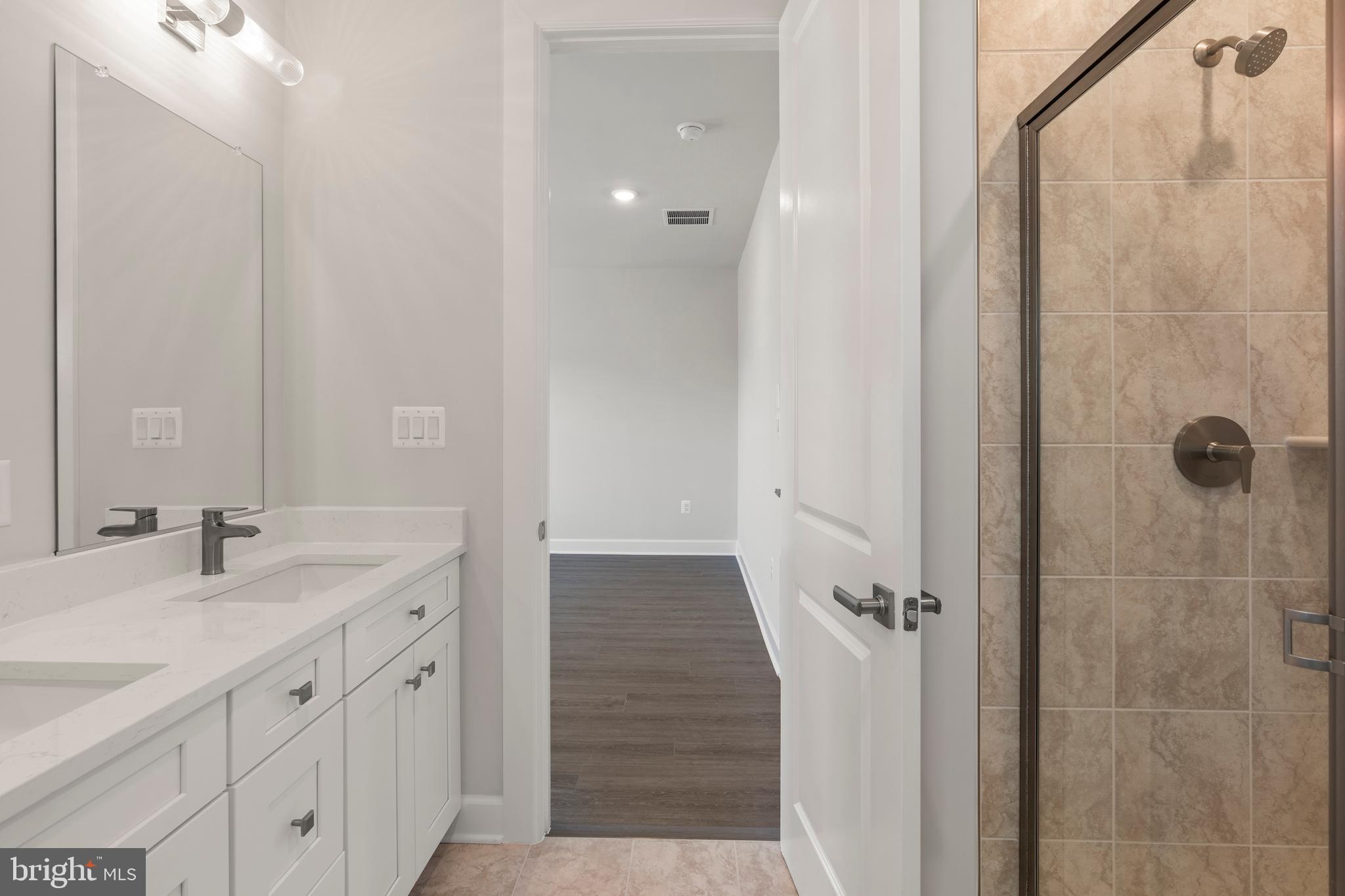 1448 Lavender Cliff Way Odenton, MD 21113 - Photo 64 of 94 a bathroom with a granite countertop sink two mirror and shower