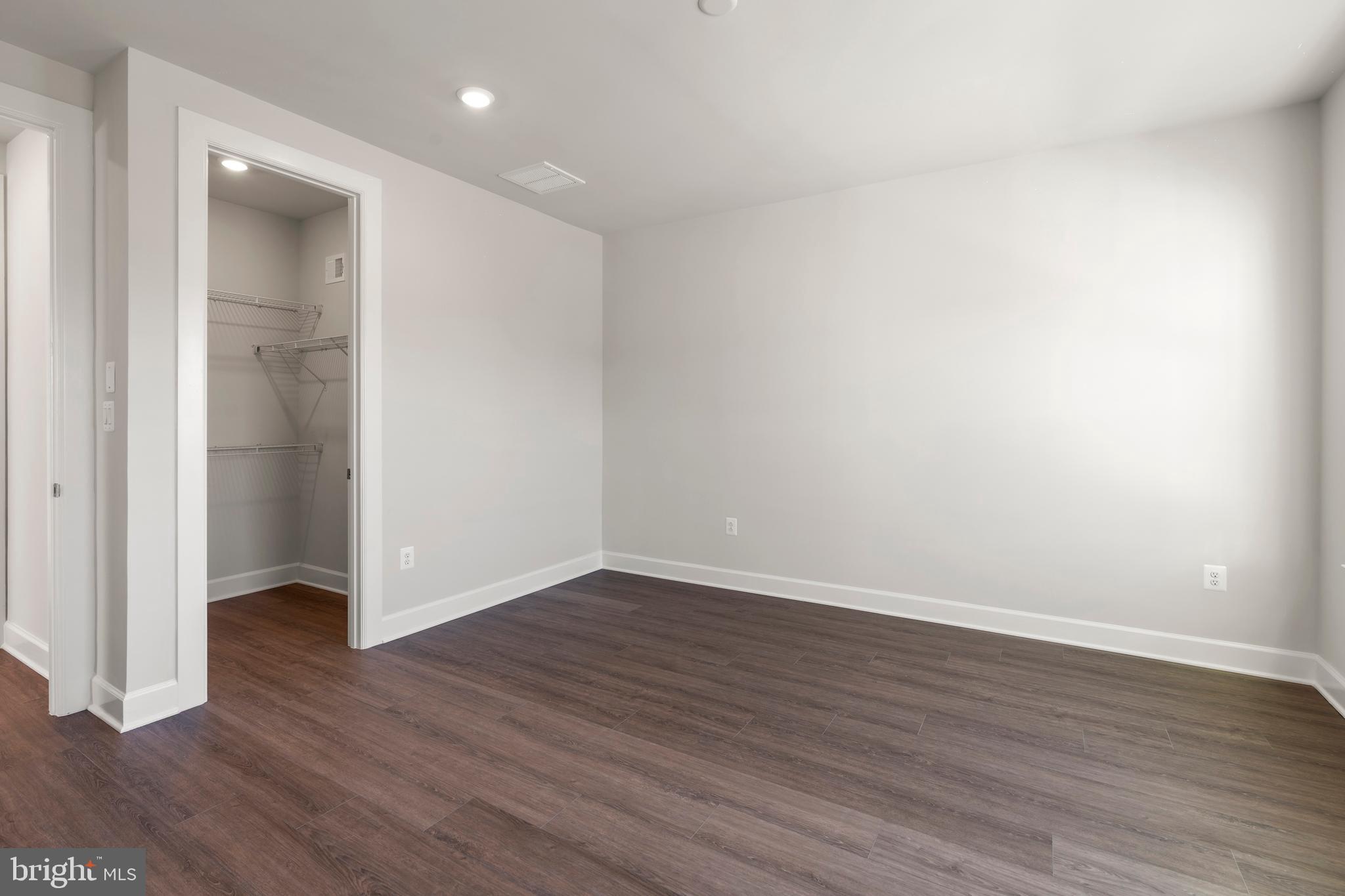 1448 Lavender Cliff Way Odenton, MD 21113 - Photo 66 of 94 a view of an empty room with wooden floor