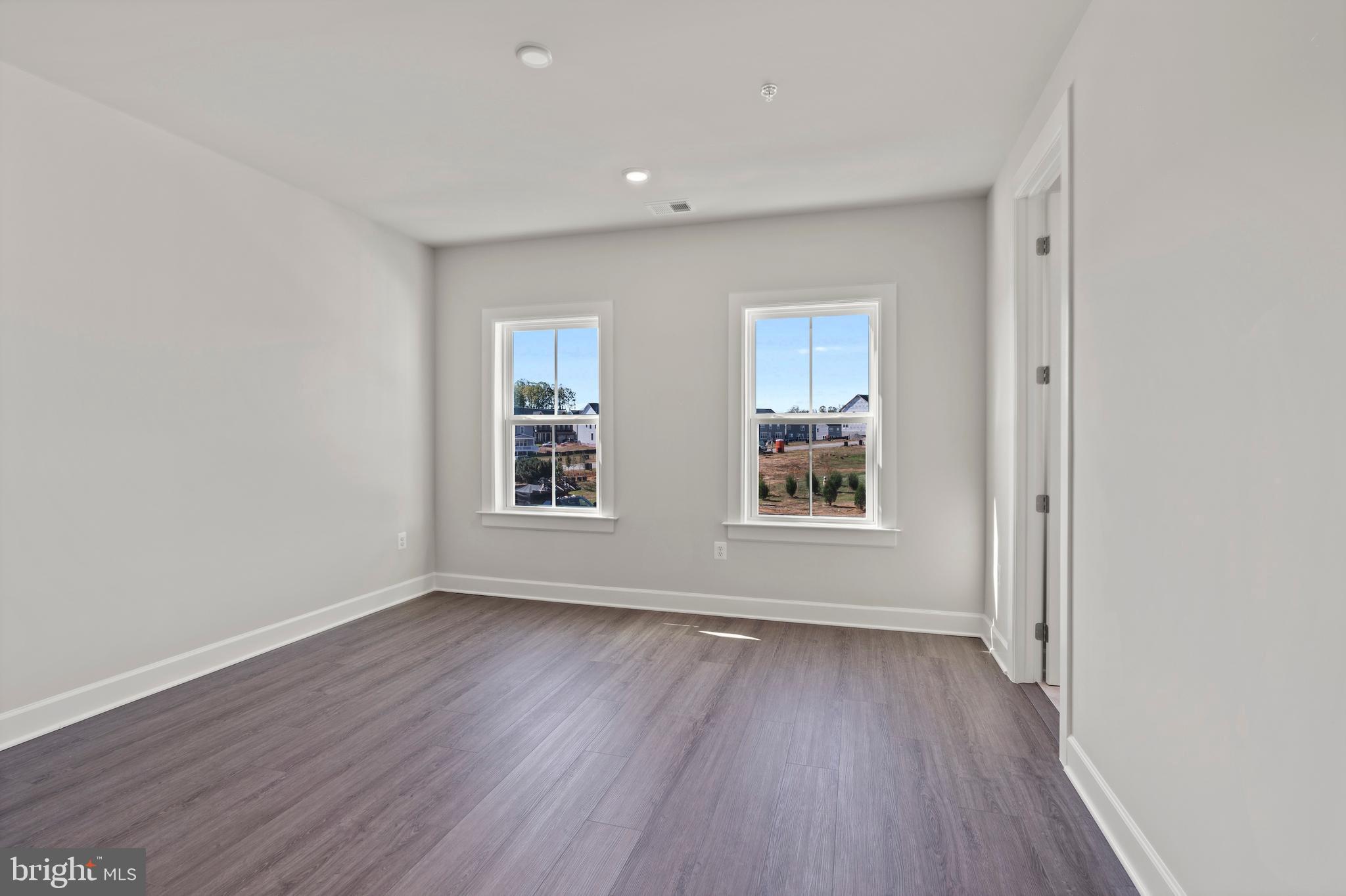 1448 Lavender Cliff Way Odenton, MD 21113 - Photo 67 of 94 an empty room with wooden floor and windows