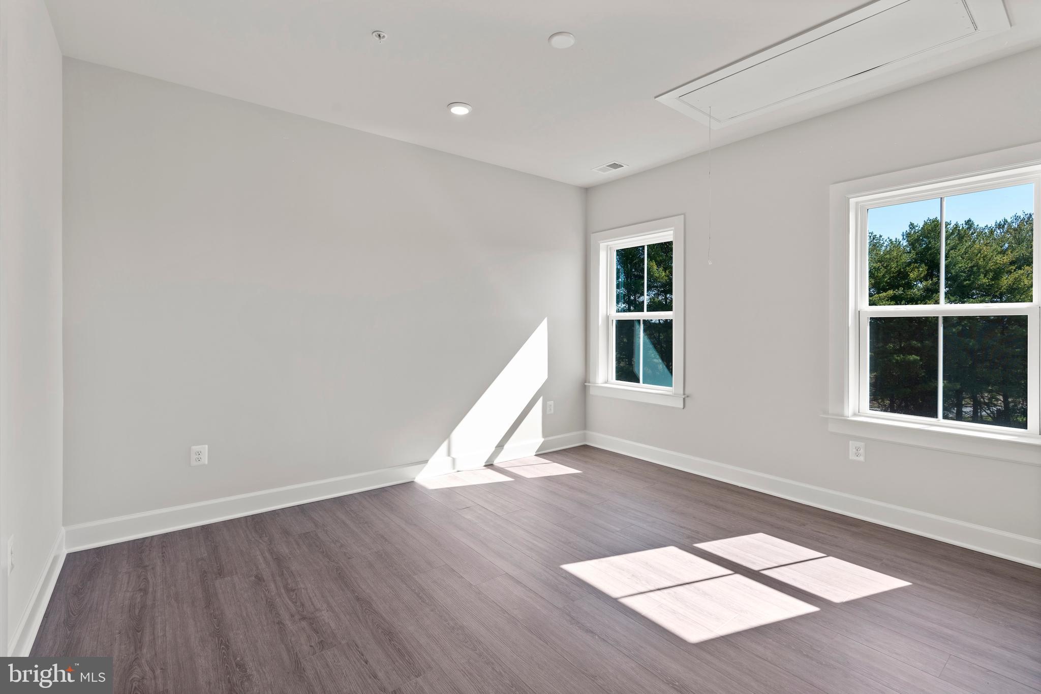1448 Lavender Cliff Way Odenton, MD 21113 - Photo 68 of 94 an empty room with wooden floor and windows