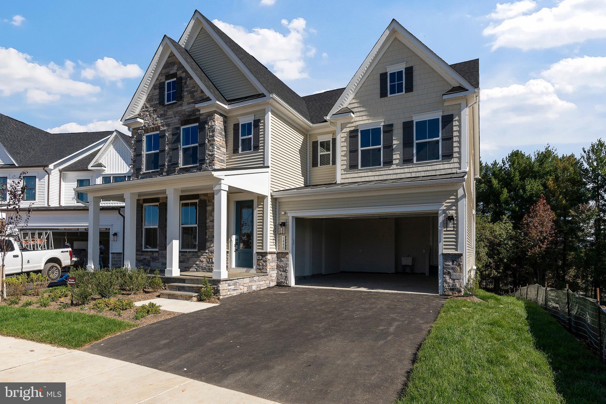 1448 Lavender Cliff Way Odenton, MD 21113 - Photo 8 of 94 a front view of a house with a yard and garage