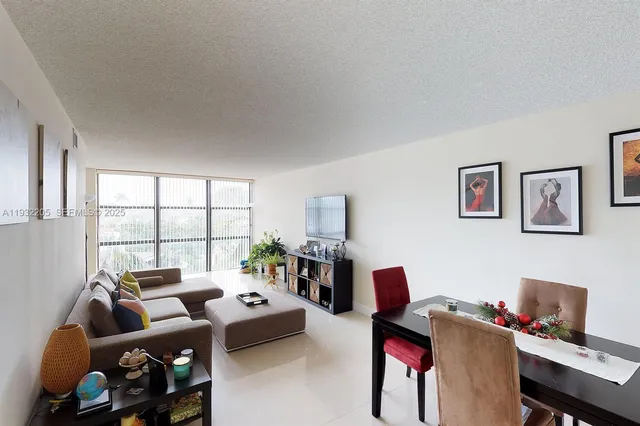 a living room with furniture window and a flat screen tv