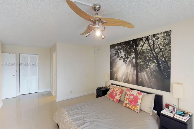 a bedroom with a bed and a painting on the wall