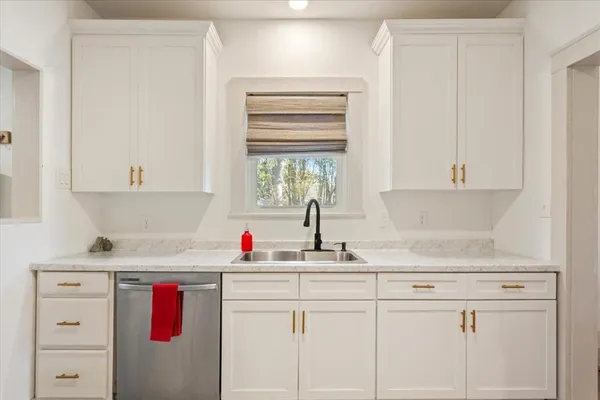 a kitchen with sink cabinets and window