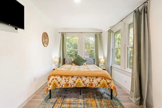 a bed sitting in a bedroom next to a window