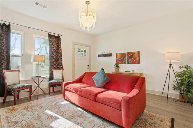 a living room with furniture and a chandelier