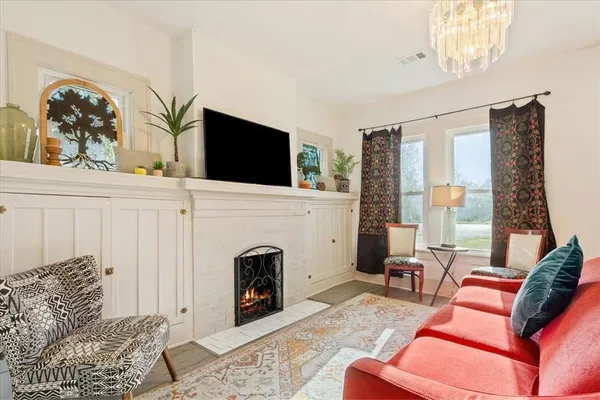 a living room with furniture a flat screen tv and a fireplace