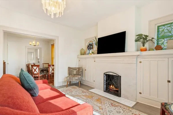 a living room with furniture a fireplace and a flat screen tv