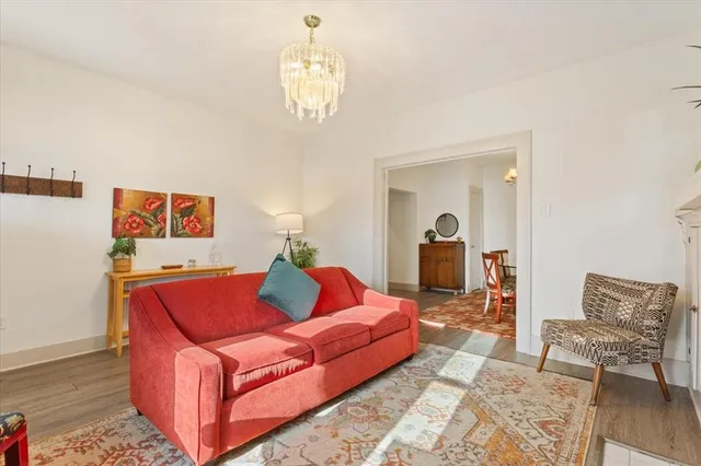 a living room with furniture and a chandelier