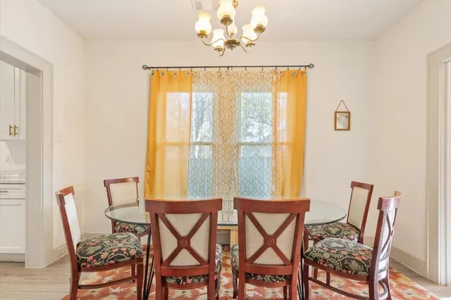 a view of a dining room with furniture and chandelier