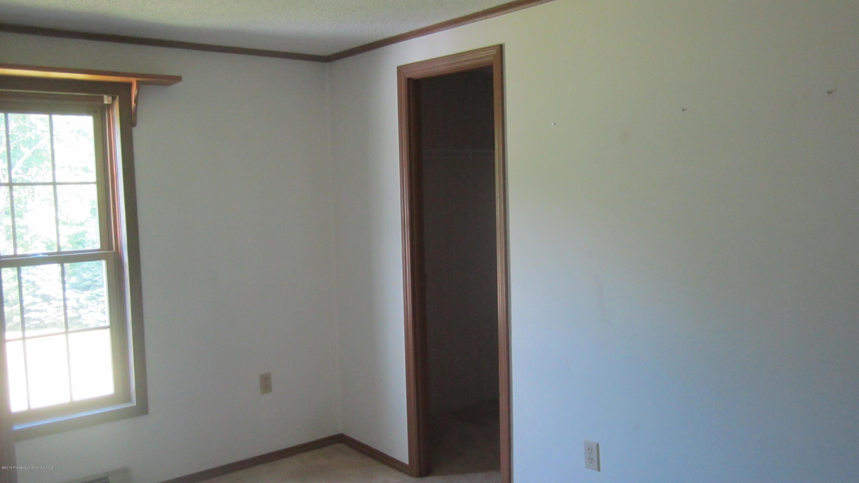 325 Rail Road Nicholson, PA 18446 - Photo 12 of 15 an empty room with wooden floor and windows