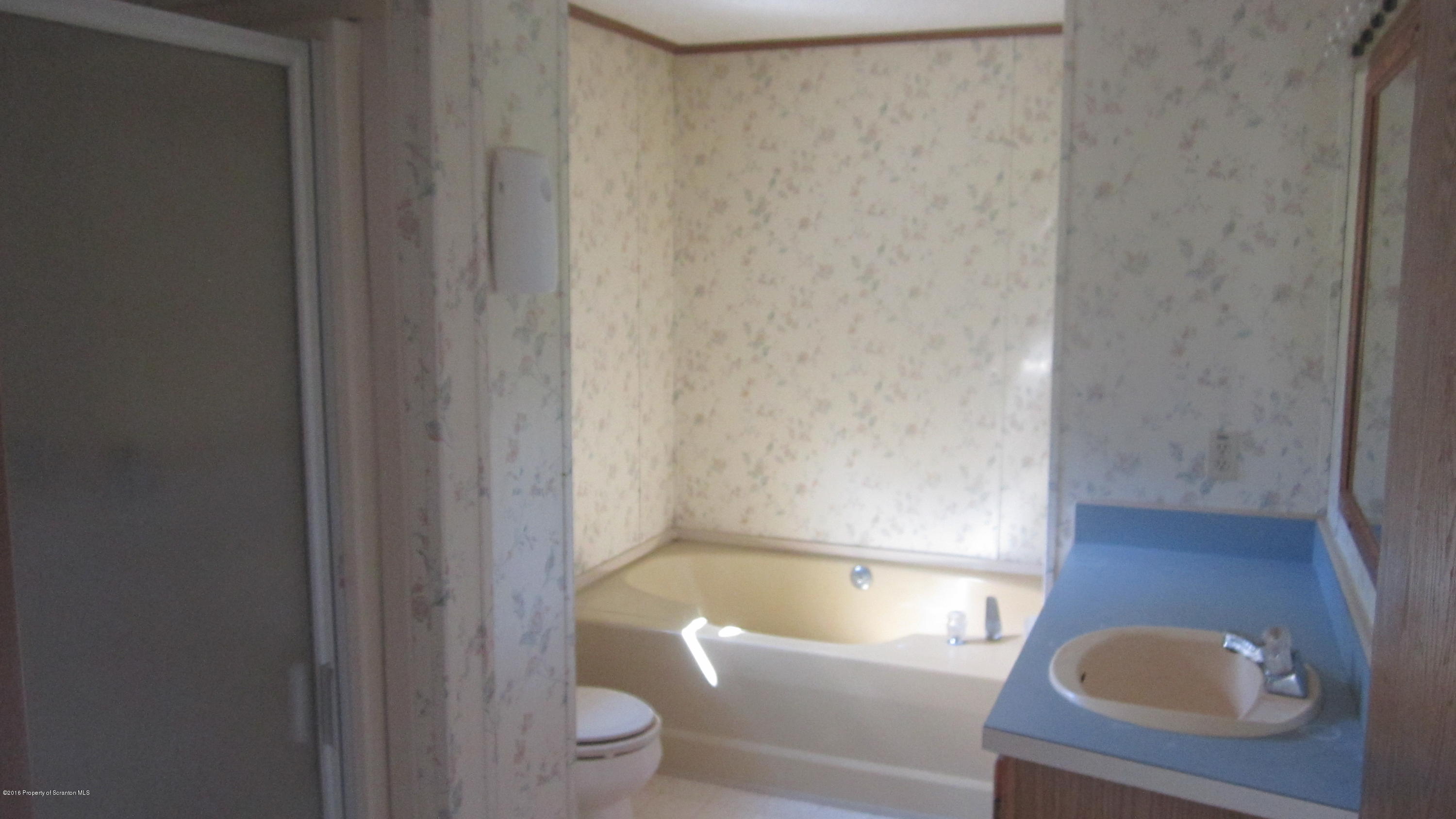 325 Rail Road Nicholson, PA 18446 - Photo 14 of 15 a bathroom with a tub and a toilet