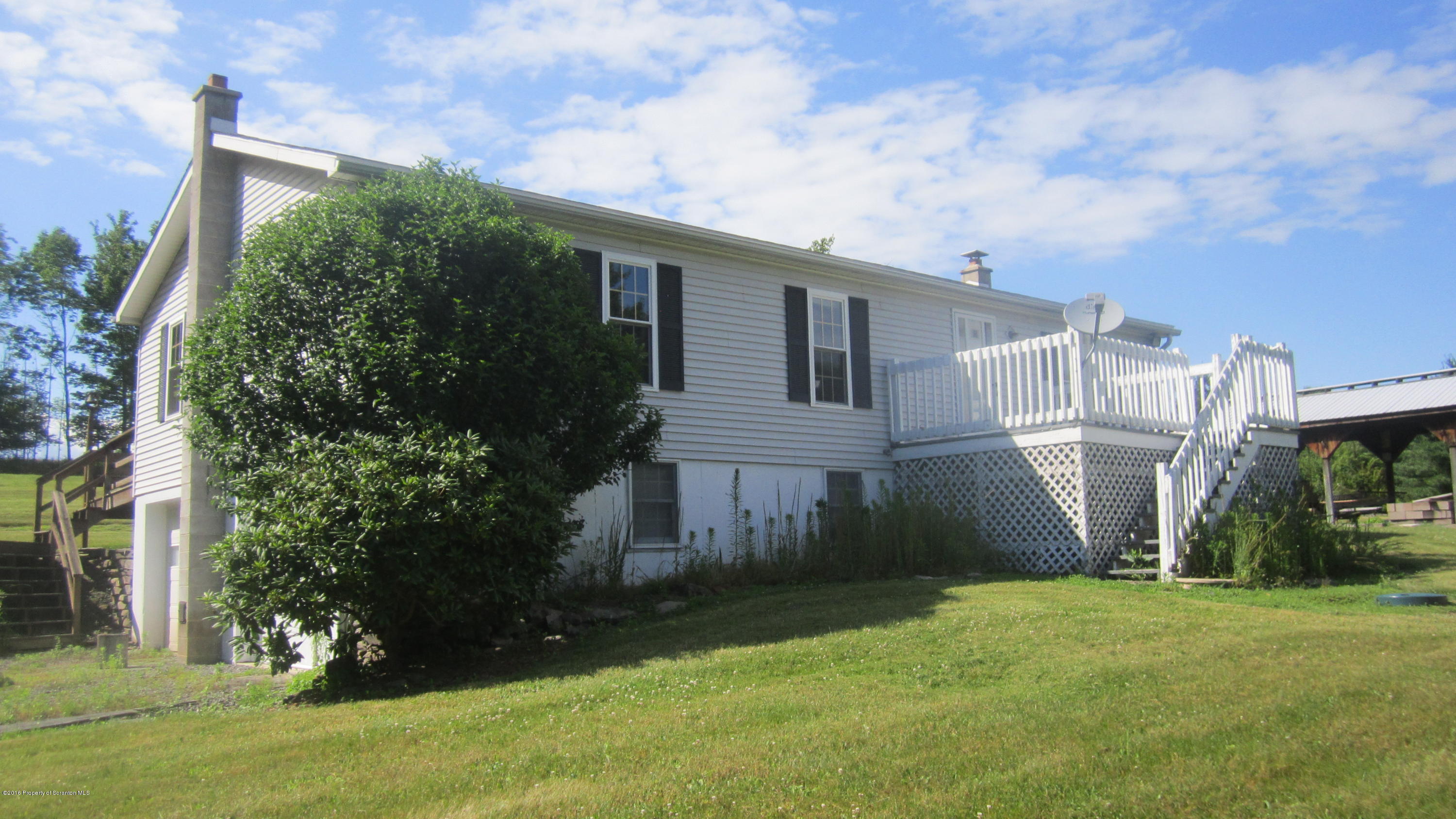 325 Rail Road Nicholson, PA 18446 - Photo 3 of 15 a backyard of a house with plants and large tree