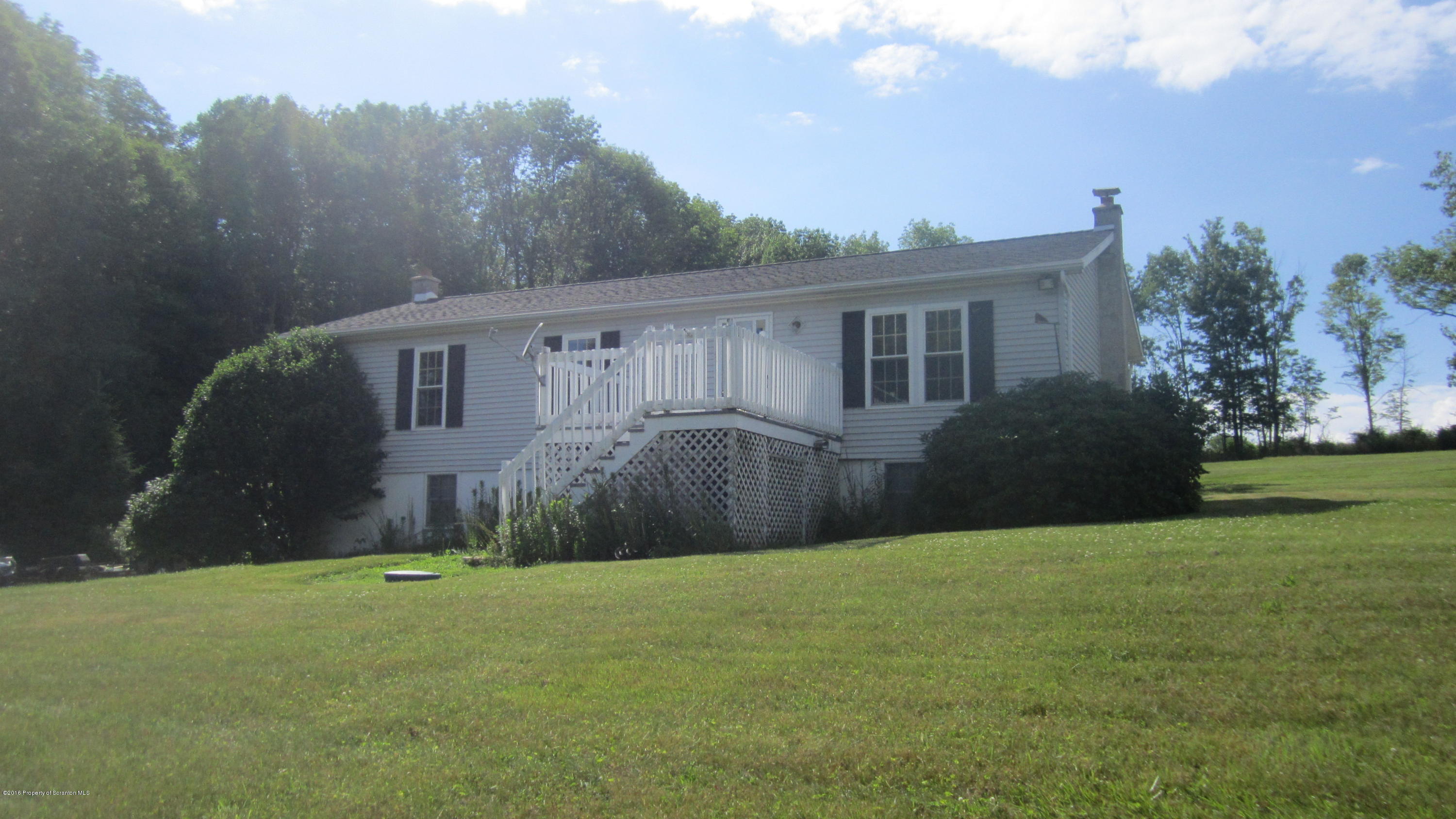 325 Rail Road Nicholson, PA 18446 - Photo 5 of 15 a view of a house with backyard and garden