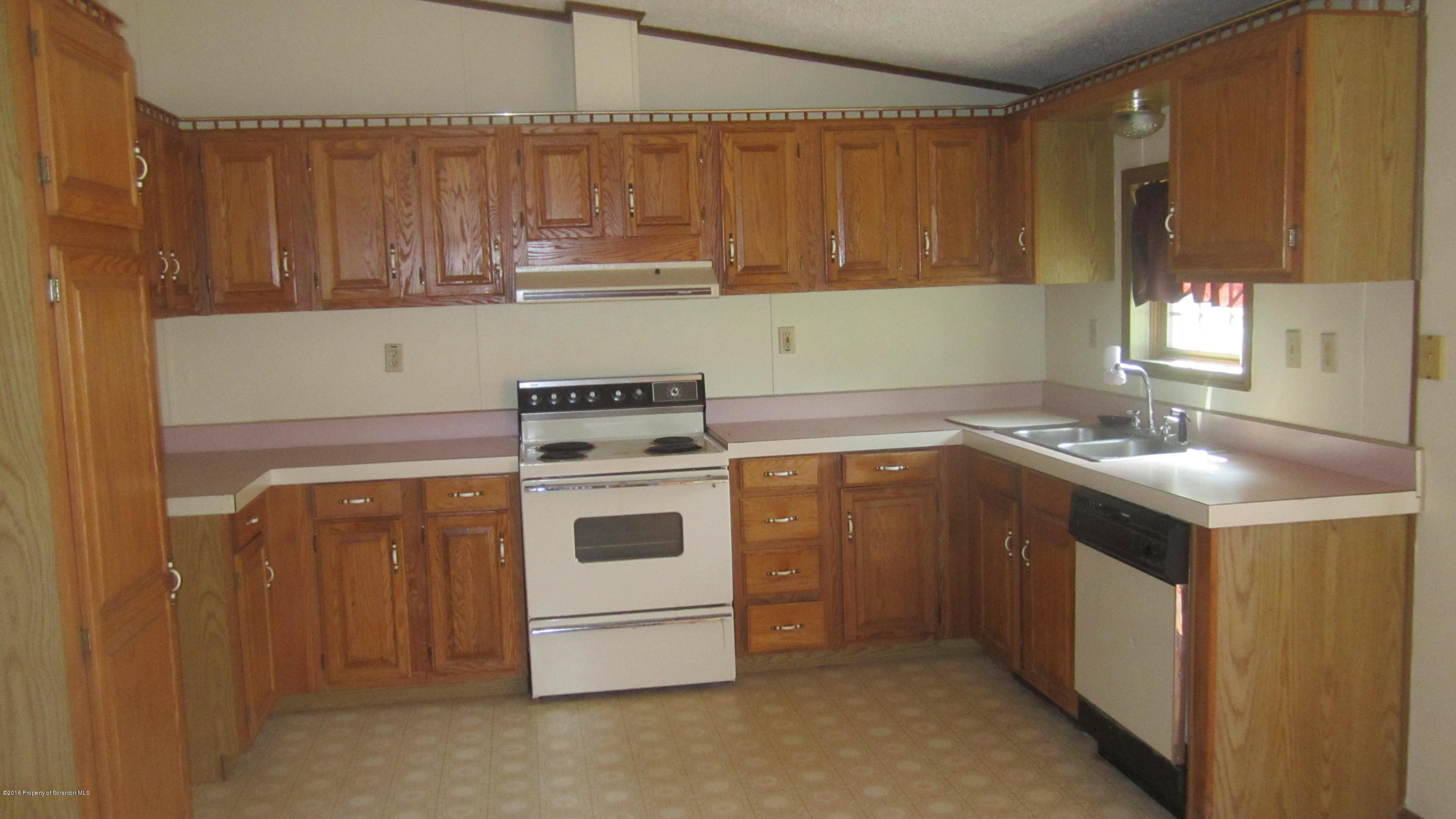 325 Rail Road Nicholson, PA 18446 - Photo 9 of 15 a kitchen with a stove sink and cabinets