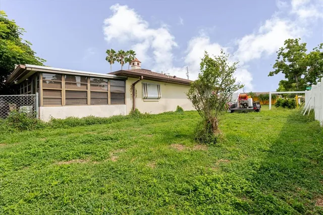 an aerial view of residential houses with outdoor space and trees