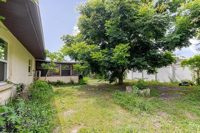 an aerial view of residential houses with outdoor space and trees
