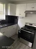 a close view of stove top oven and cabinets