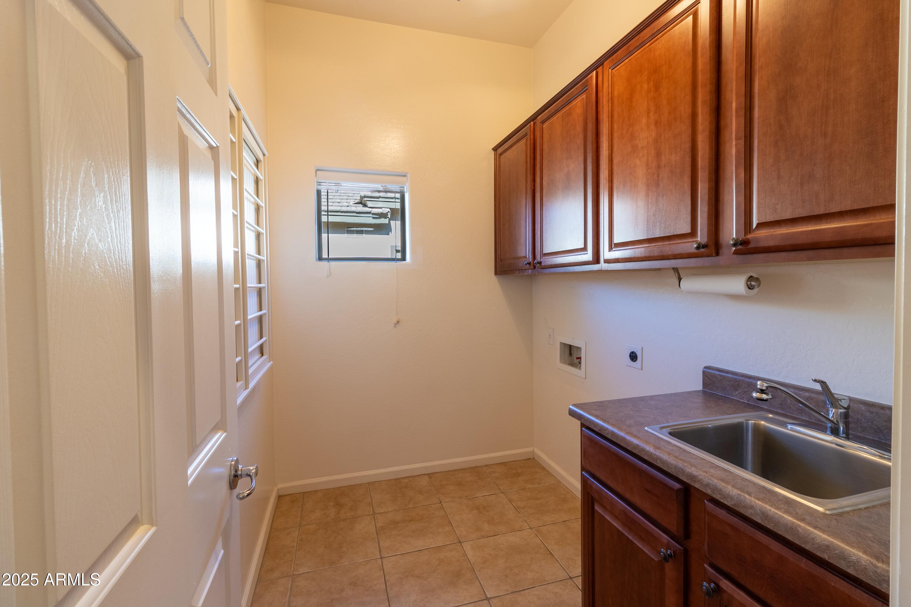 4241 East Andre Avenue Gilbert, AZ 85298 - Photo 11 of 39 a kitchen with stainless steel appliances granite countertop a refrigerator and a sink