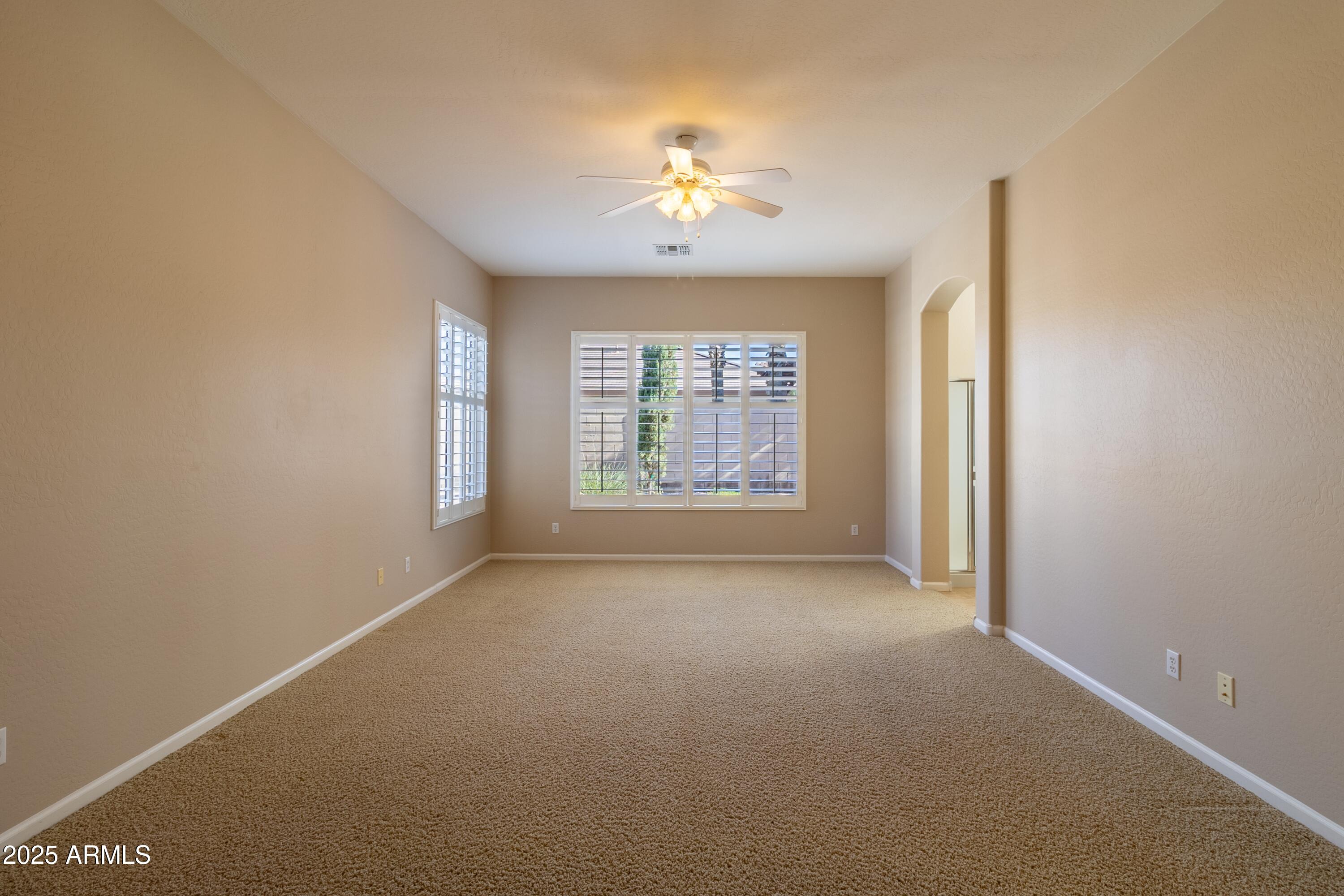 4241 East Andre Avenue Gilbert, AZ 85298 - Photo 12 of 39 a view of a livingroom with a ceiling fan and window
