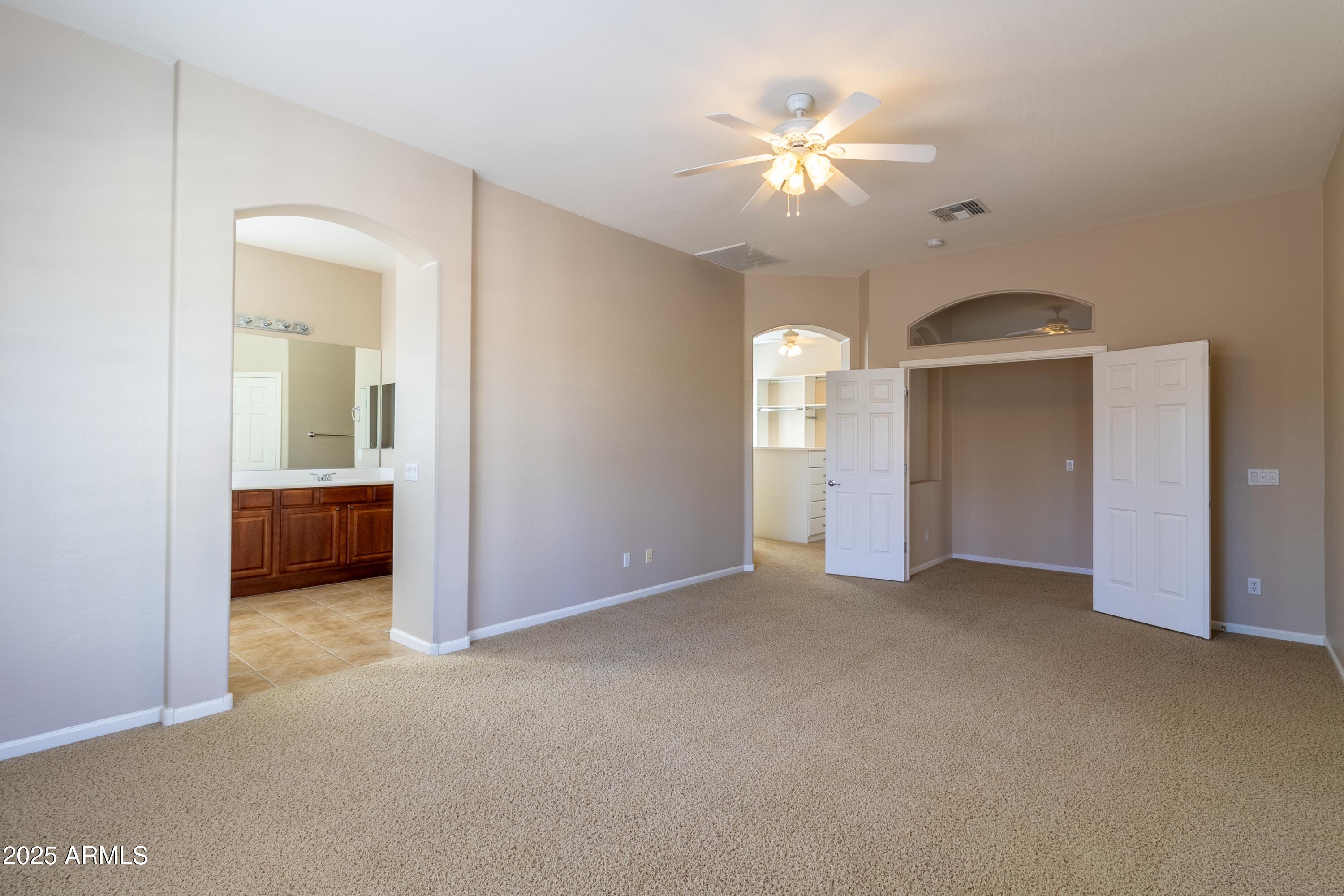 4241 East Andre Avenue Gilbert, AZ 85298 - Photo 13 of 39 a view of a chandelier fan and a livingroom with a chandelier