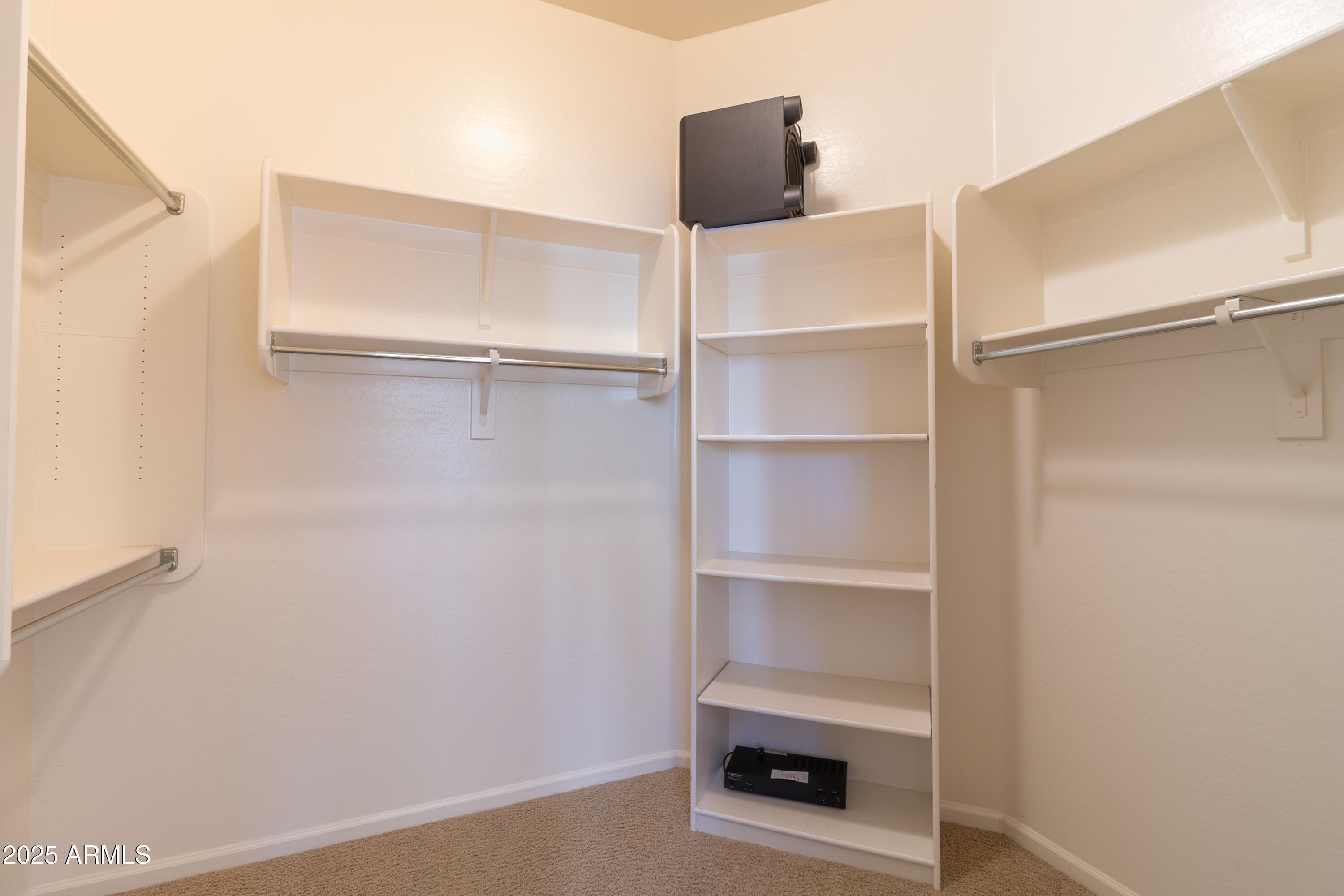 4241 East Andre Avenue Gilbert, AZ 85298 - Photo 16 of 39 a room with a closet and wooden floor