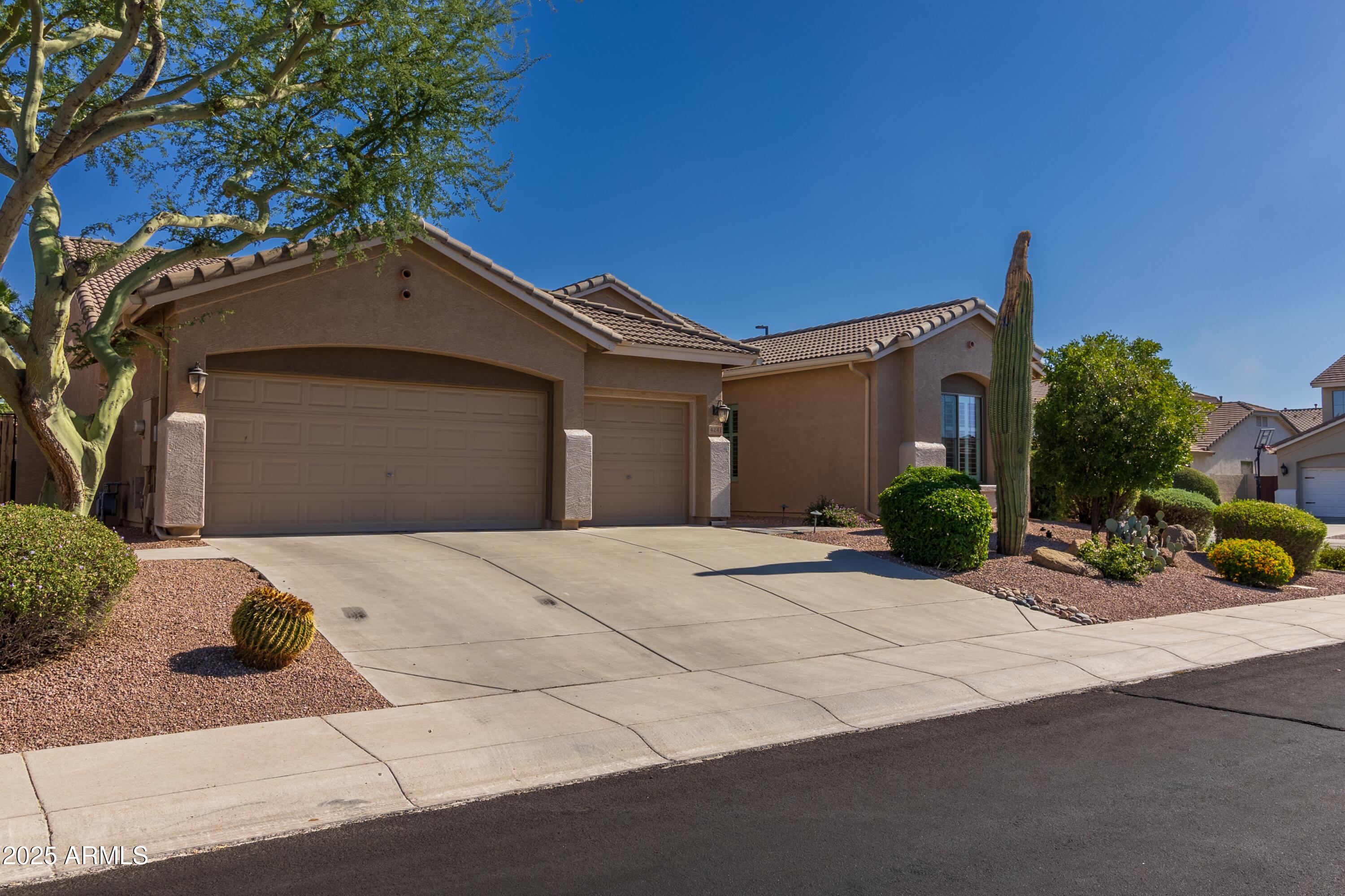 4241 East Andre Avenue Gilbert, AZ 85298 - Photo 2 of 39 a front view of a house with a yard and garage