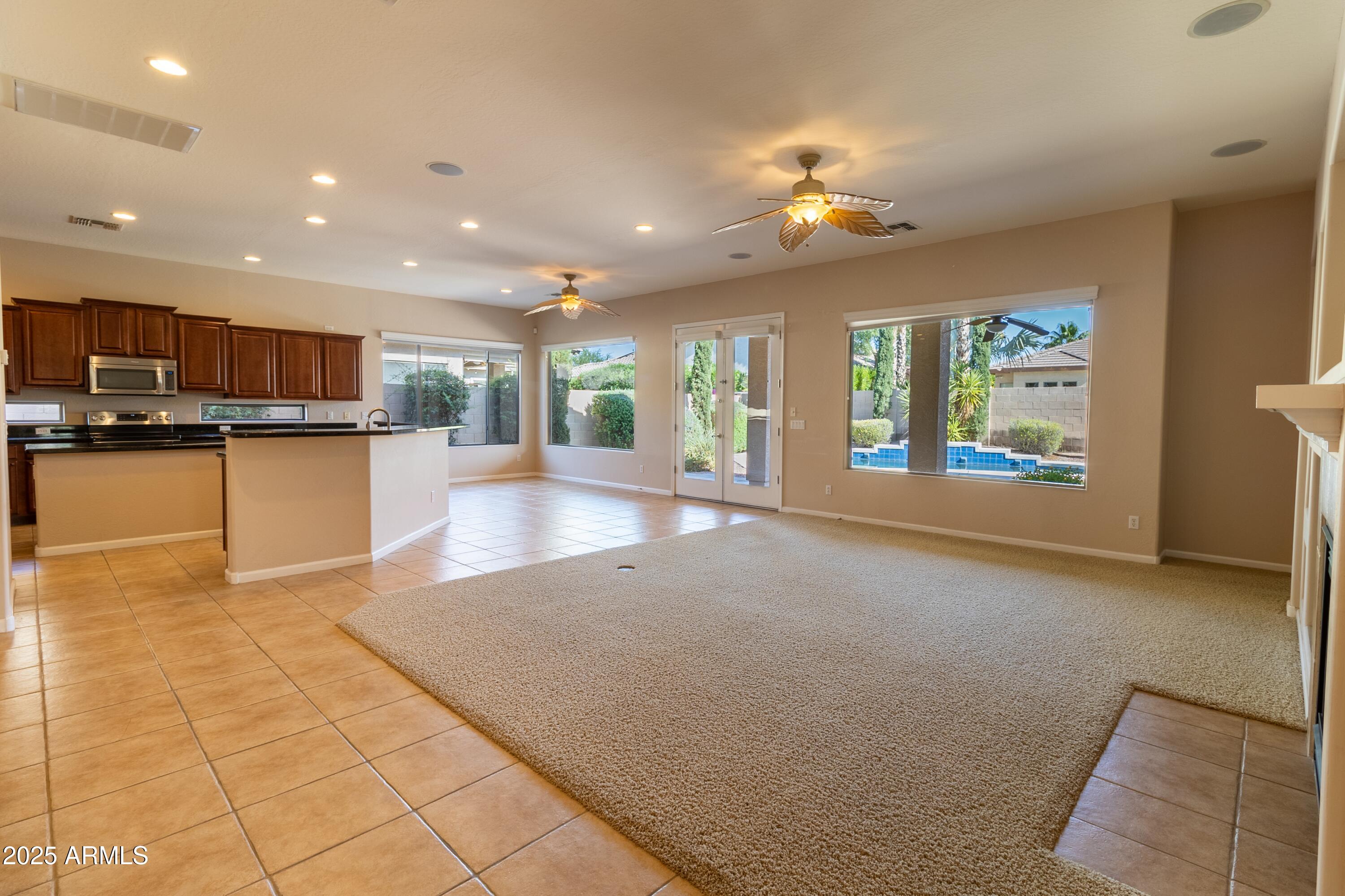 4241 East Andre Avenue Gilbert, AZ 85298 - Photo 4 of 39 a view of a kitchen with kitchen island stainless steel appliances refrigerator stove microwave and cabinets
