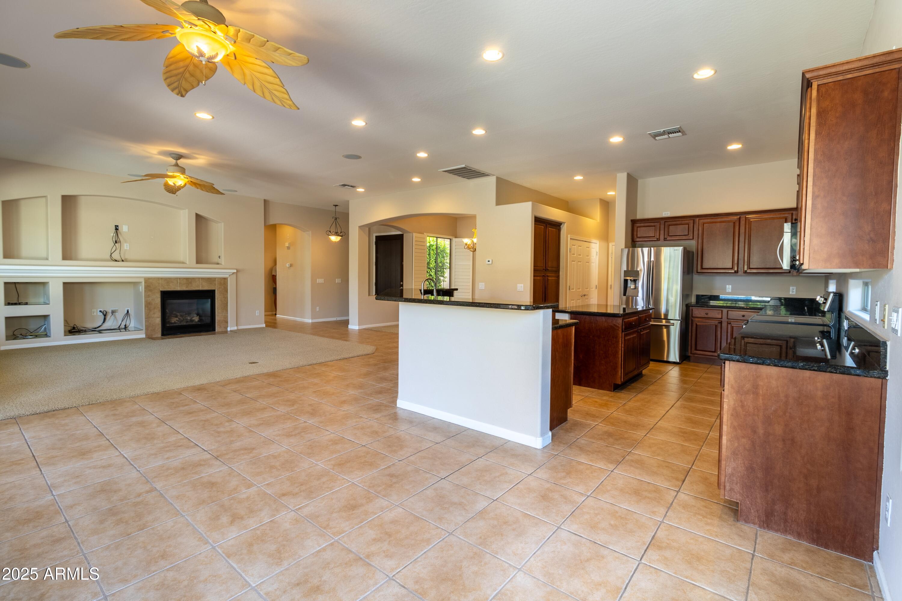4241 East Andre Avenue Gilbert, AZ 85298 - Photo 5 of 39 a large kitchen with a large counter top stainless steel appliances and cabinets