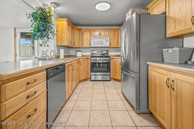 a view of a kitchen with furniture and a window
