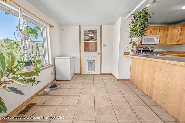 a bedroom with a bed and a dresser next to a window