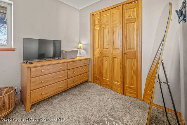 a bed room with a bed and dresser