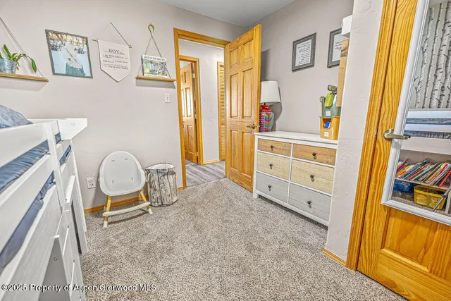 a view of an empty room with large windows