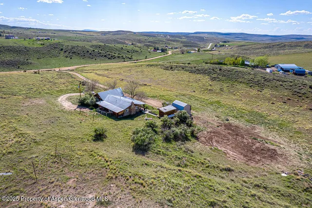 a view of a house with a yard and table